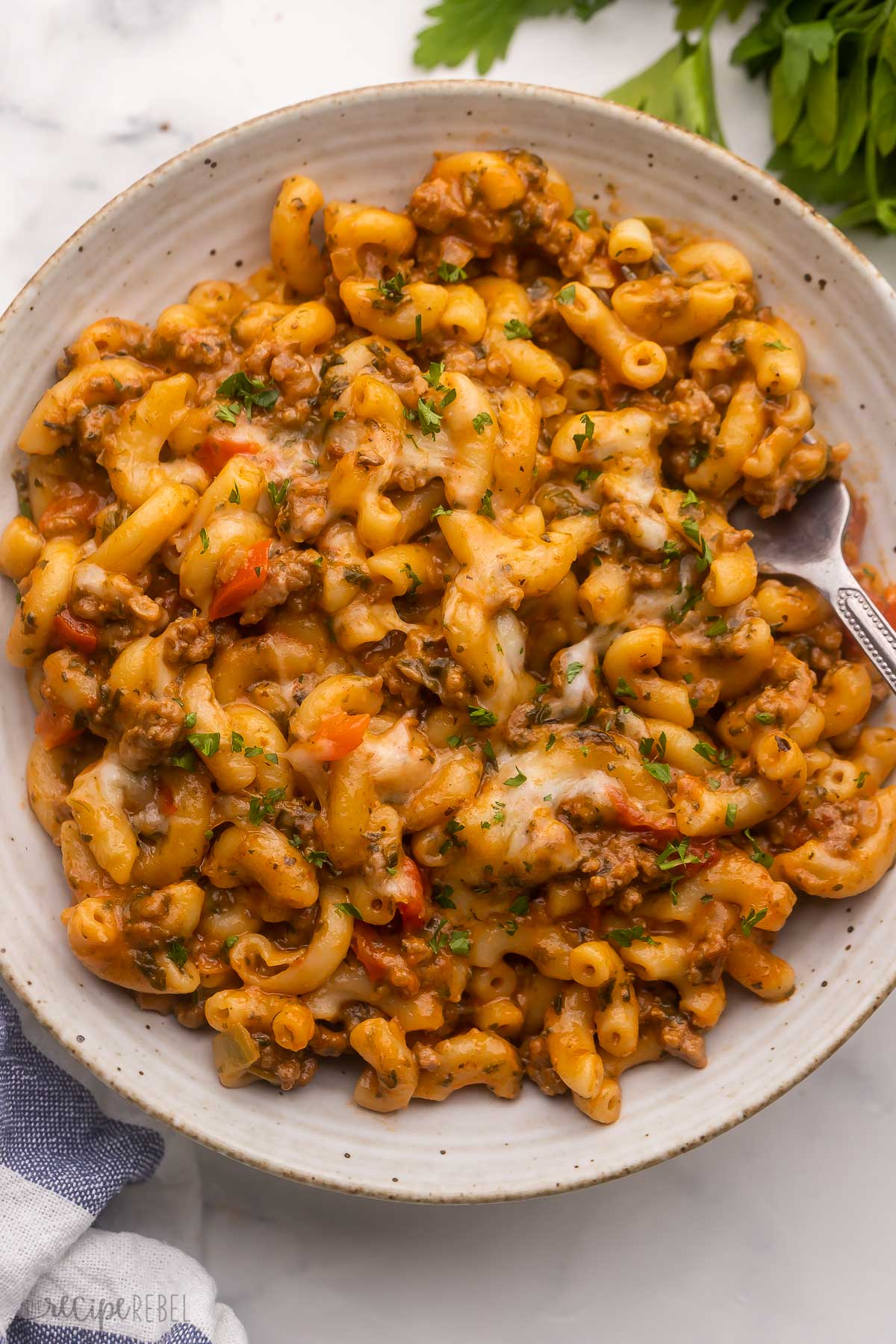 large plate filled with homemade hamburger helper and a fork beside.