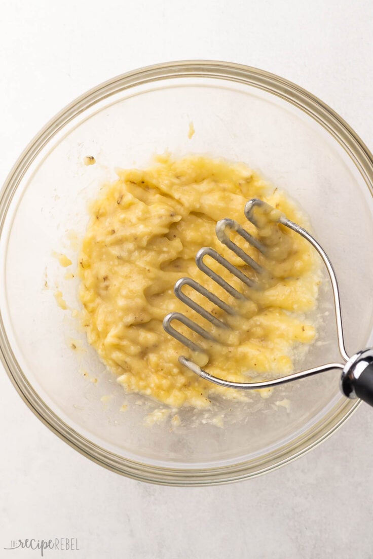 bananas mashed in a glass mixing bowl.