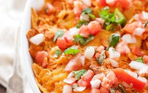 Dorito chicken casserole is garnished with salsa.