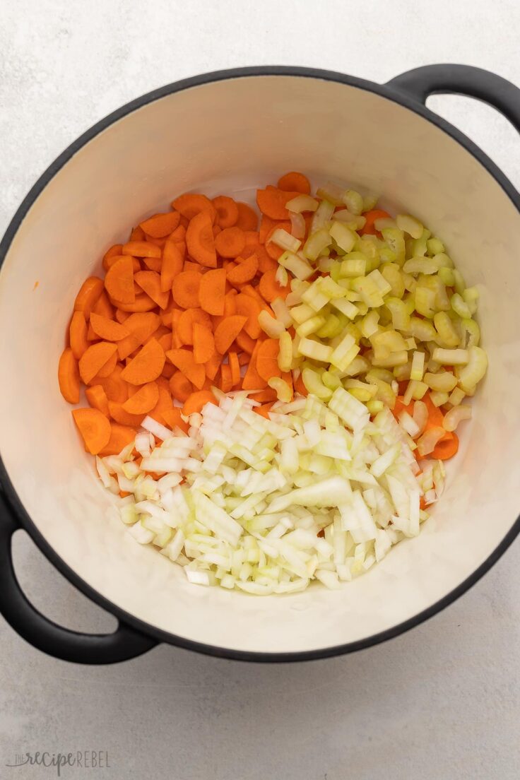 large pot filled with chopped carrots, celery and onions.