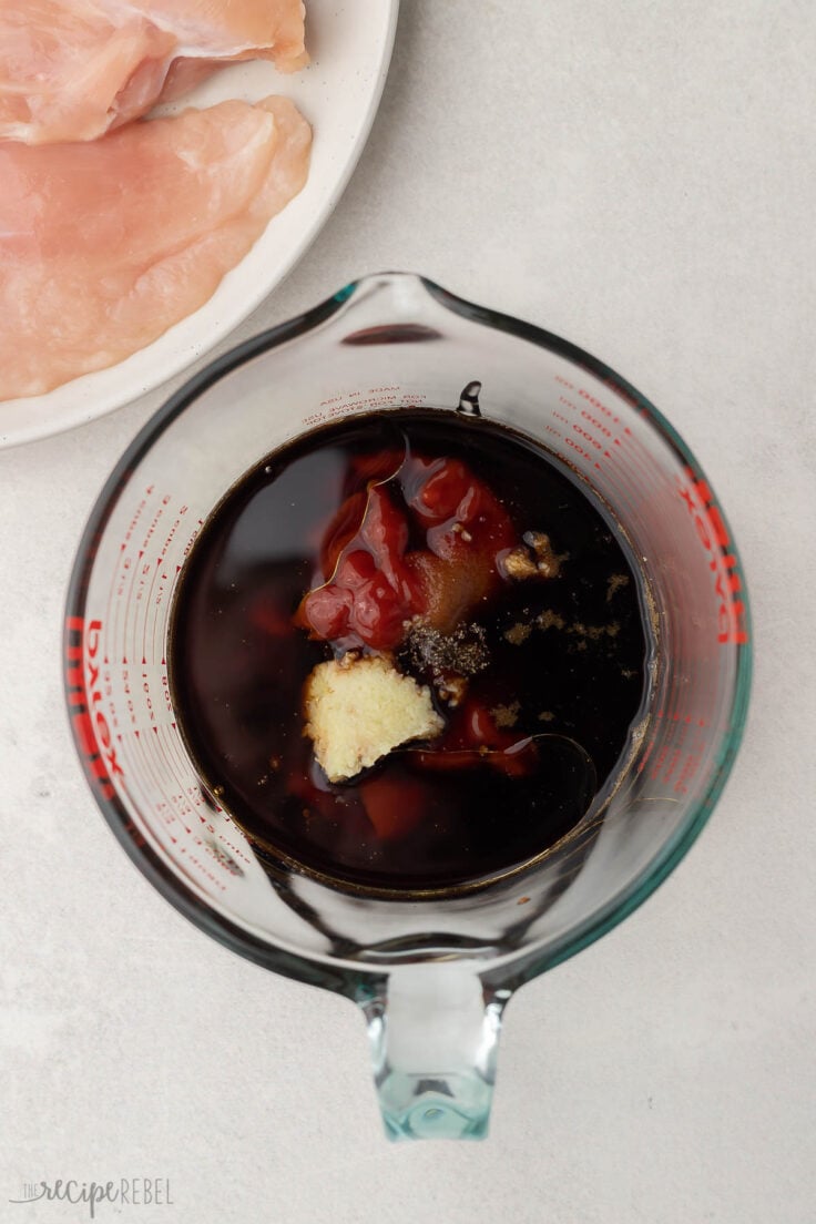 glass measuring cup filled with unstirred ingredients.