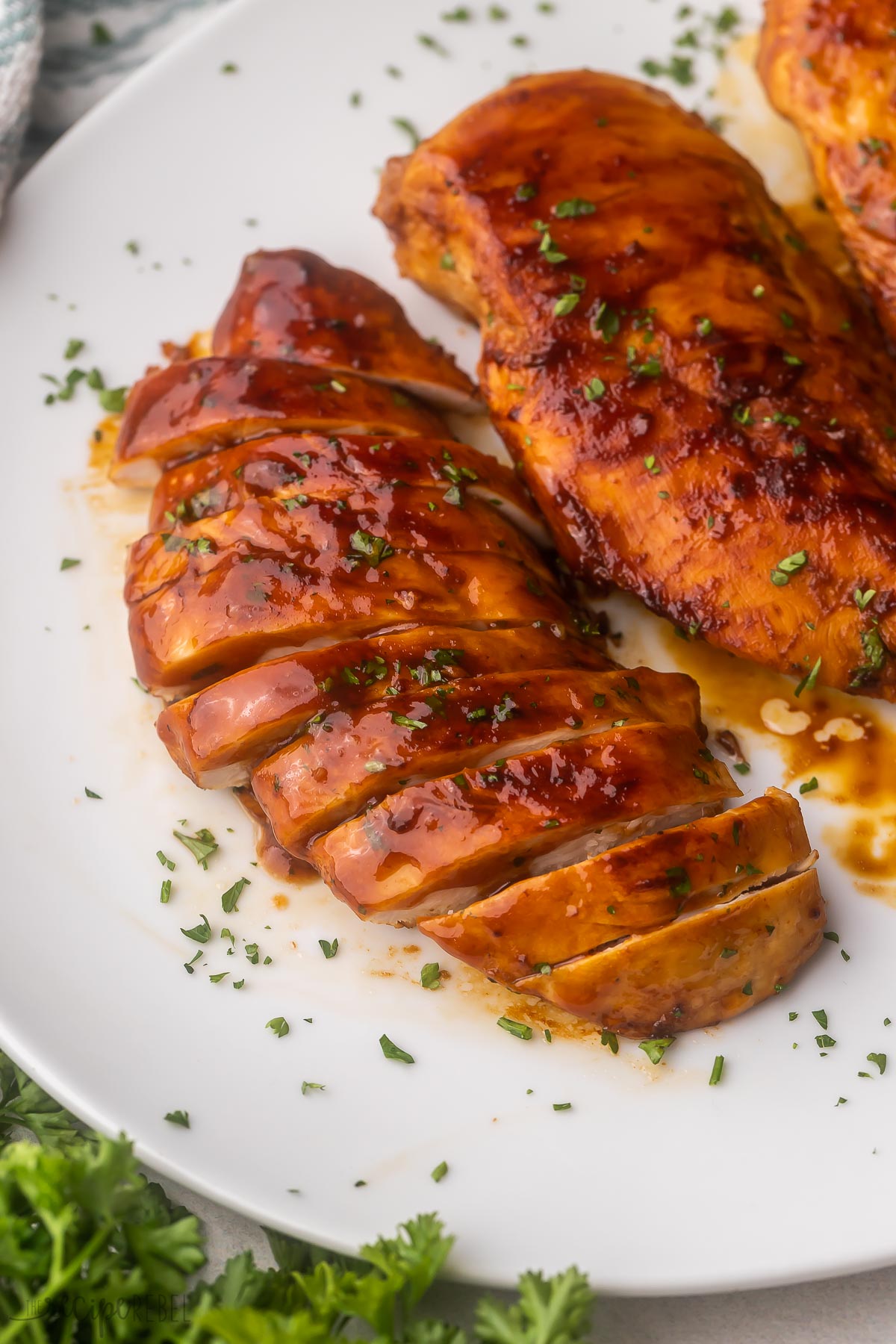 white plate with sliced chicken breast on.