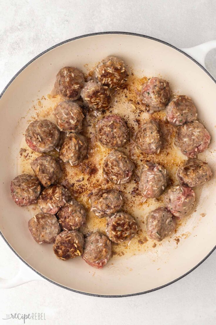 porcupine meatballs in white baking dish.
