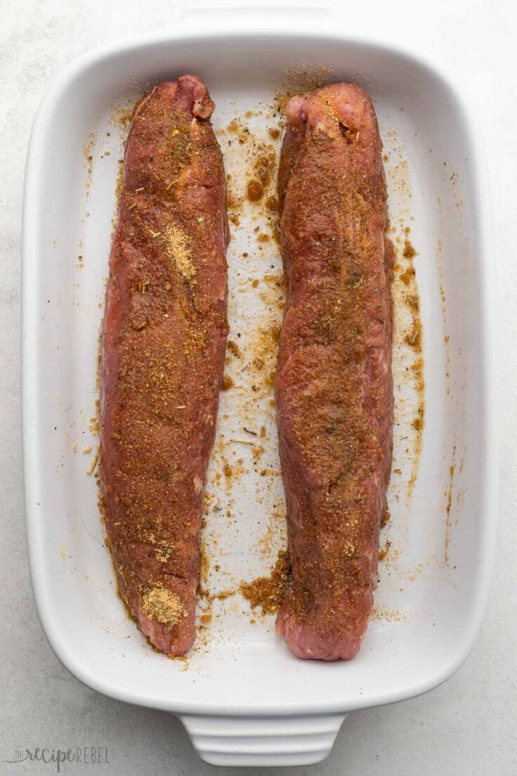 white baking dish with two unbaked tenderloins in.