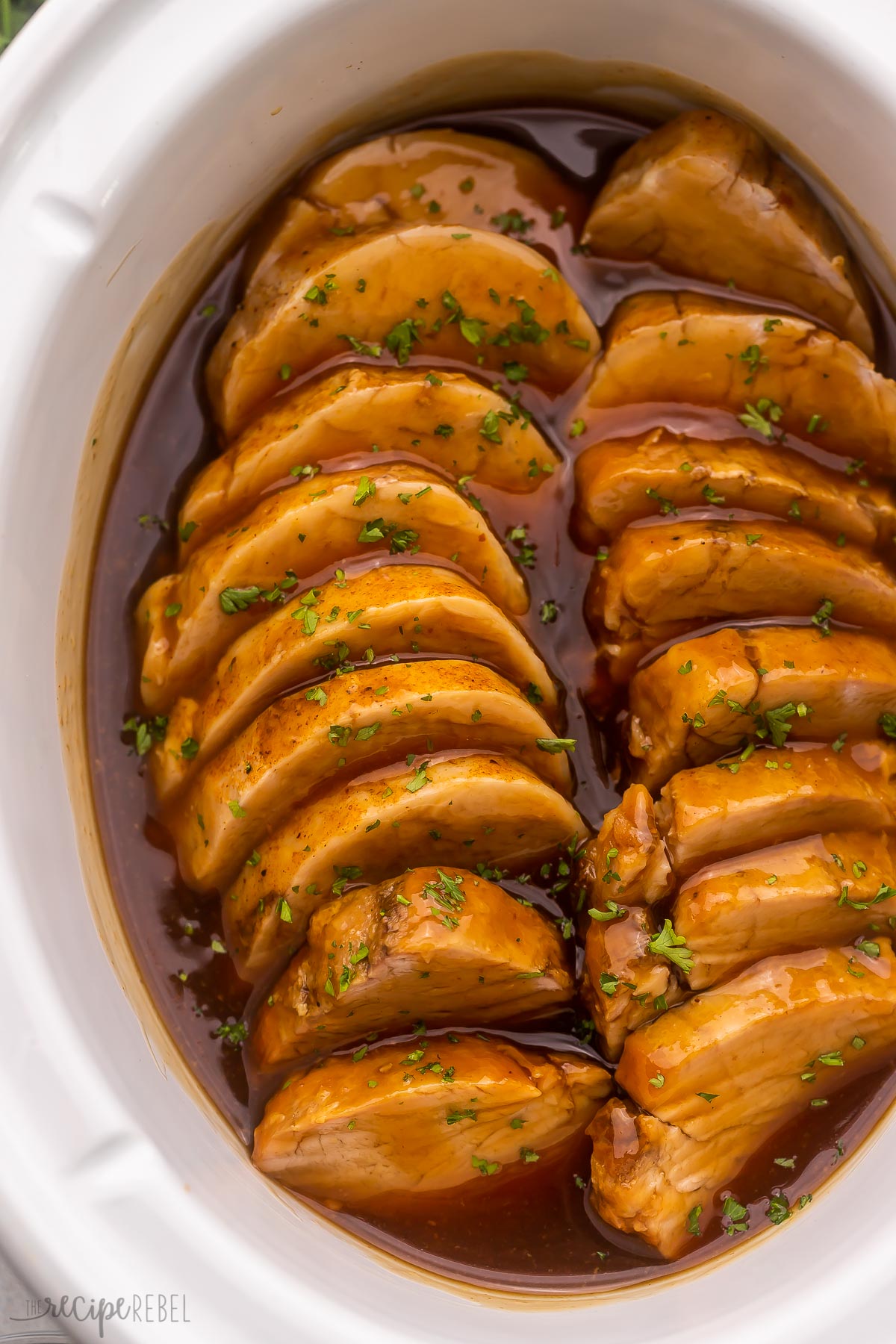 close up of sliced pork tenderloin in honey garlic sauce.