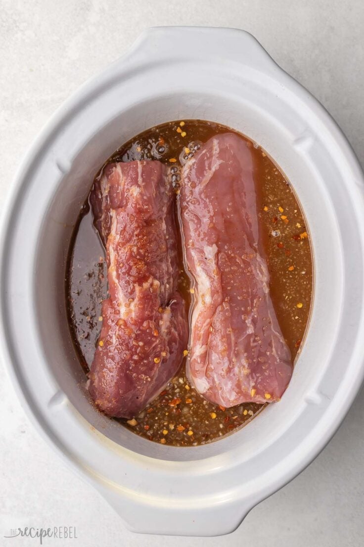 wet ingredients added to tenderloin in white slow cooker.