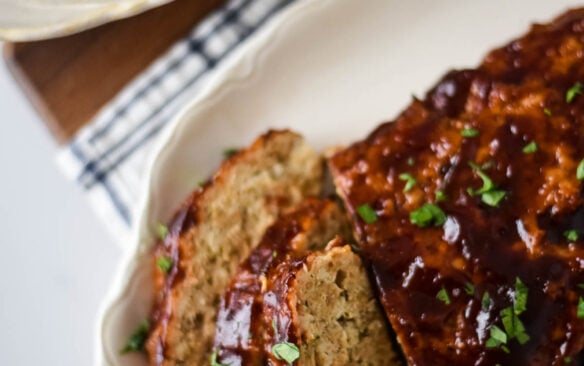 Slices of bbq chicken meatloaf are on a plate.