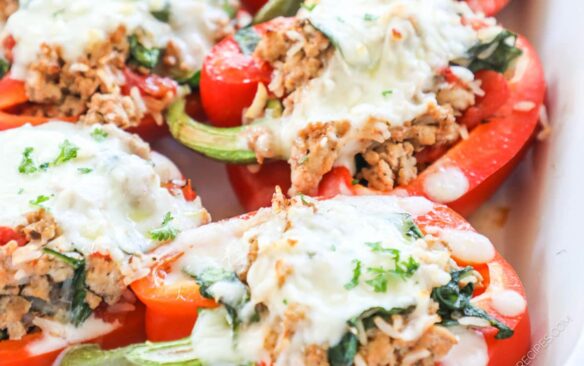 A baking dish is filled with cooked stuffed peppers.