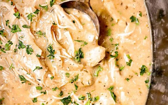 crockpot chicken and gravy in black slow cooker