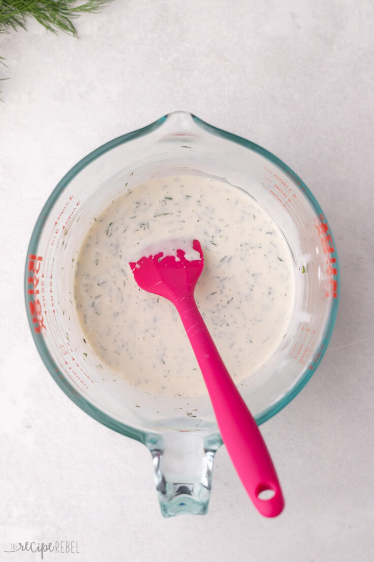 stirred ingredients and pink spatula in a measuring cup.