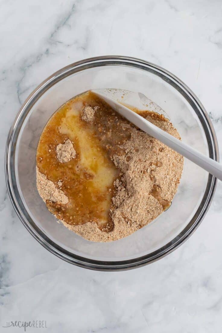 unmixed crust ingredients in glass bowl with spatula.