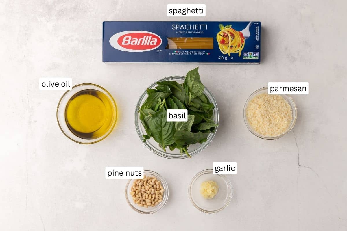 ingredients needed for pesto pasta in glass bowls.