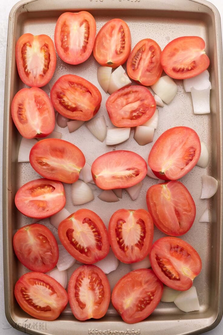 baking sheet of halved tomatoes and onions.