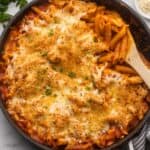 close up of large black pan full of chicken parmesan pasta.