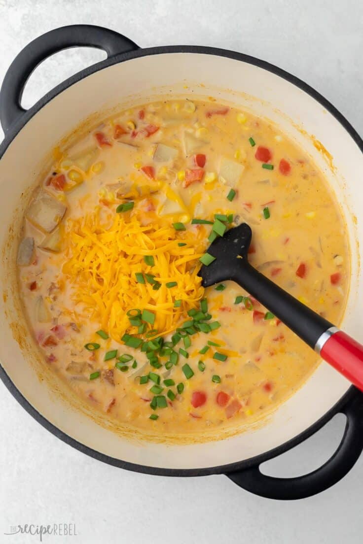 shredded cheese and green onions added to pot of corn chowder.