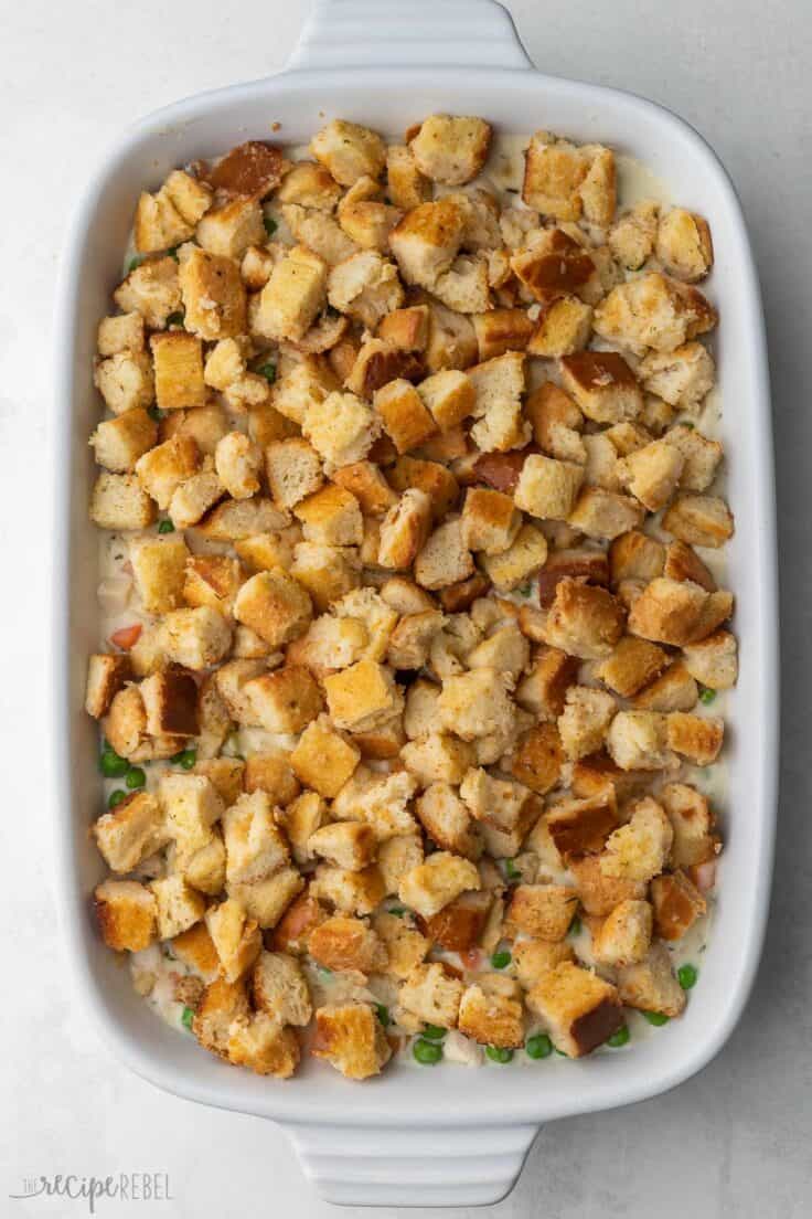 stuffing mixture on top of chicken filling in baking dish.