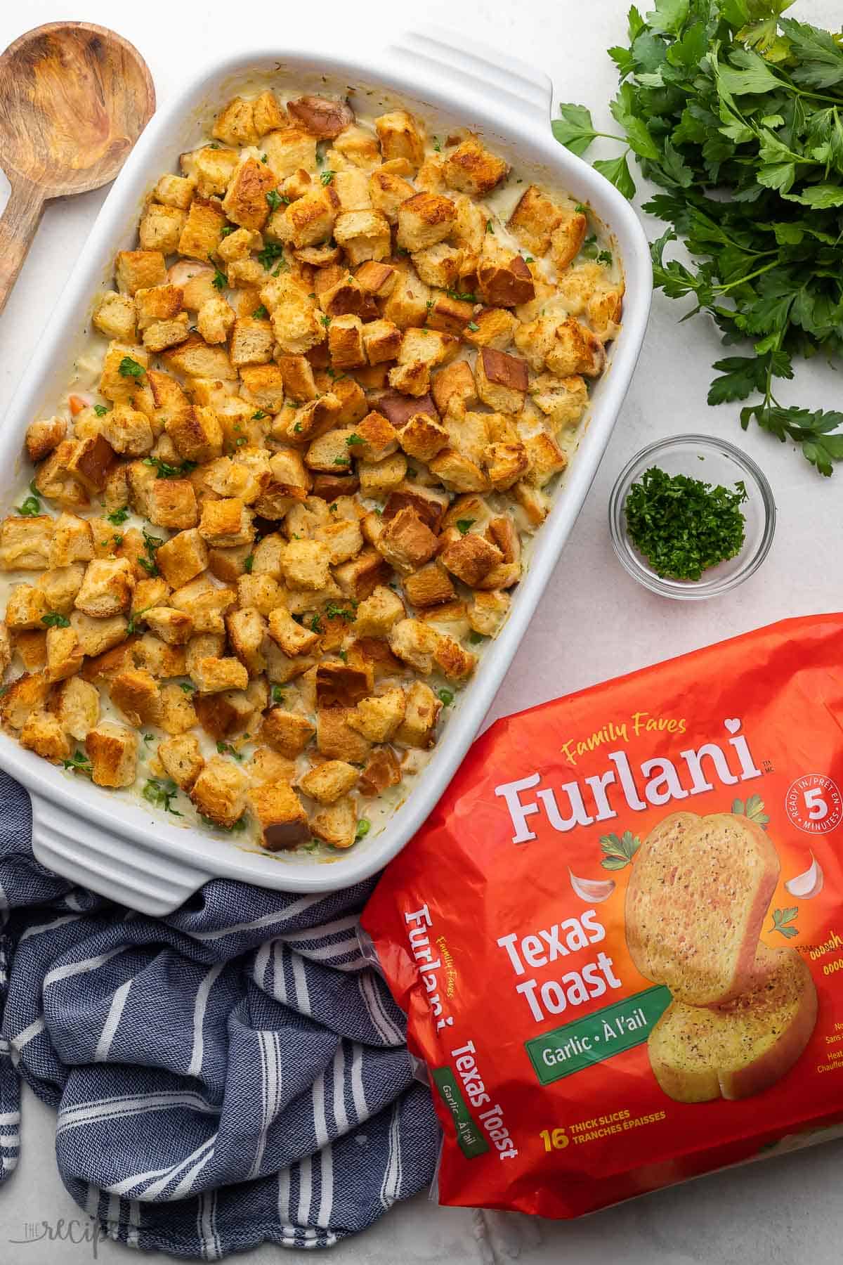overhead image of chicken and stuffing casserole with furlani garlic toast package.