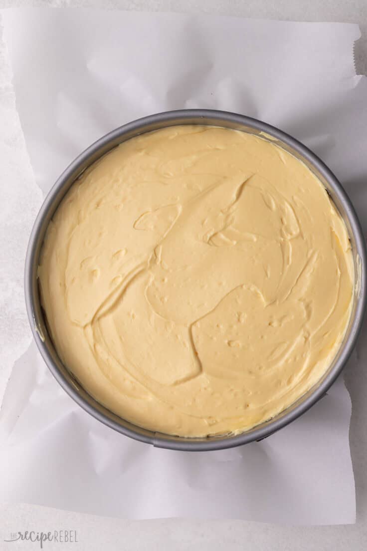grey spring form pan with nanaimo bar cheesecake in it.