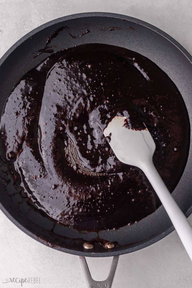 black pan with spatula and melted chocolate.
