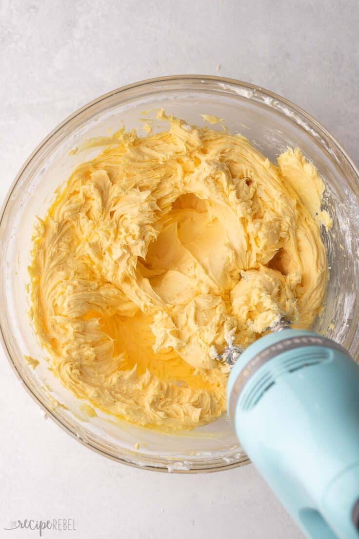 glass mixing bowl filled with cream cheese nanaimo mixture.