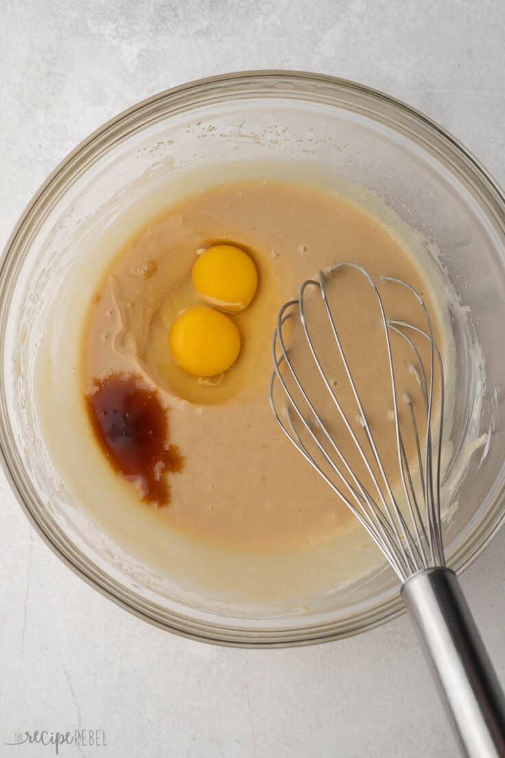 wet ingredients in bowl with steel whisk.