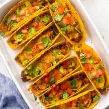 baked bbq cheeseburger tacos in a white dish.