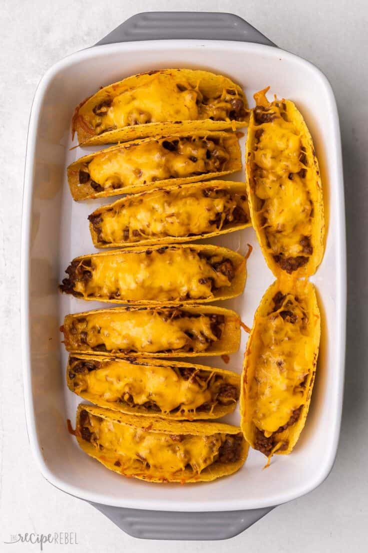 baked tacos in a large white baking dish.