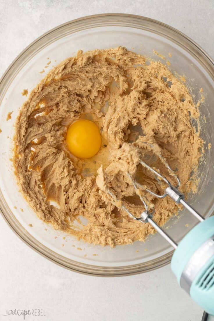 egg added to mixed ingredients in mixing bowl.