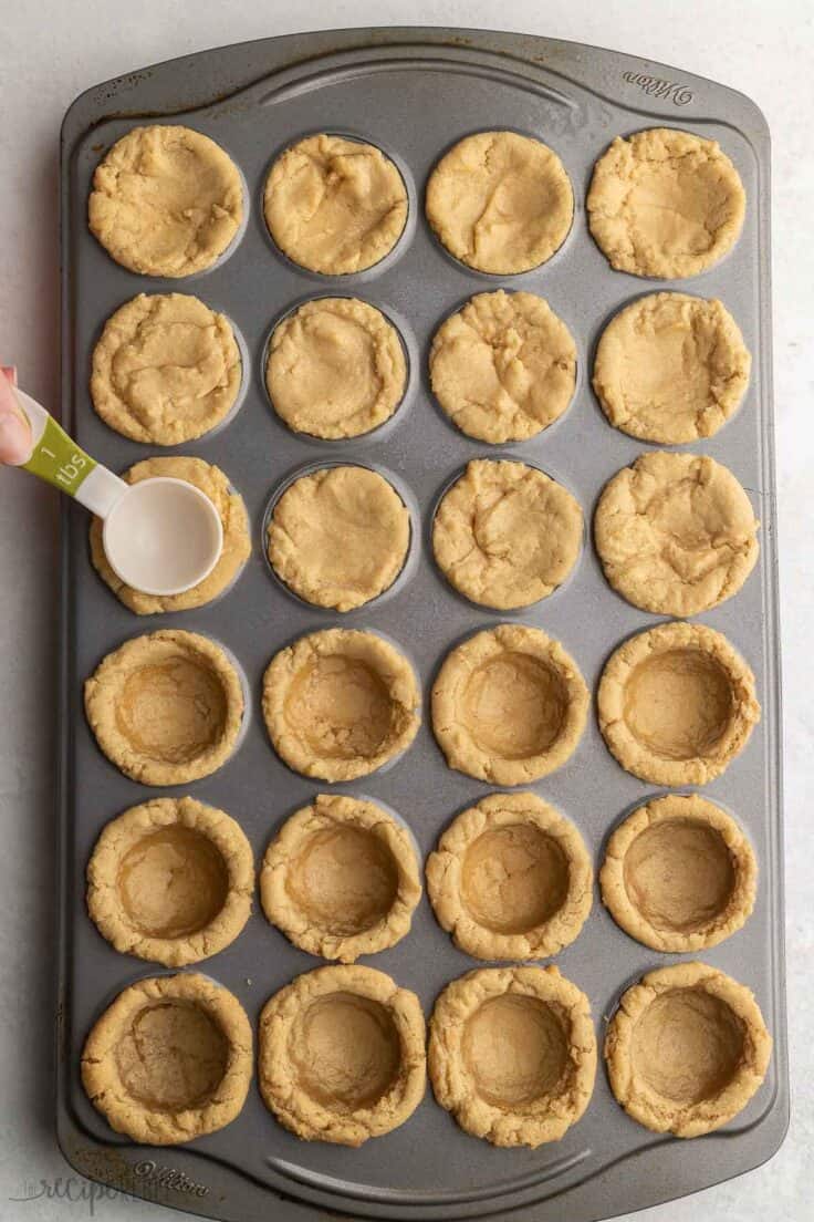 shaping the fudge puddle crust with a measuring scoop.