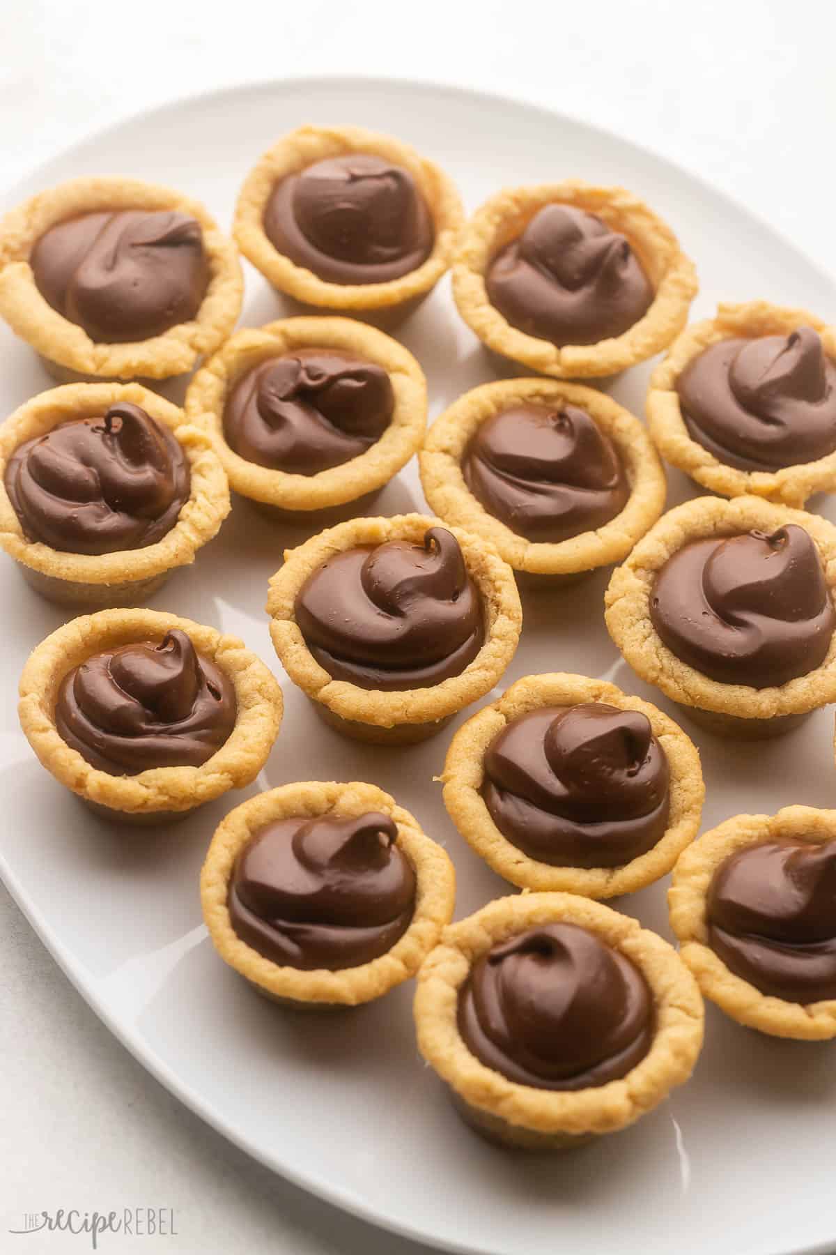 a white platter filled with fudge puddles.