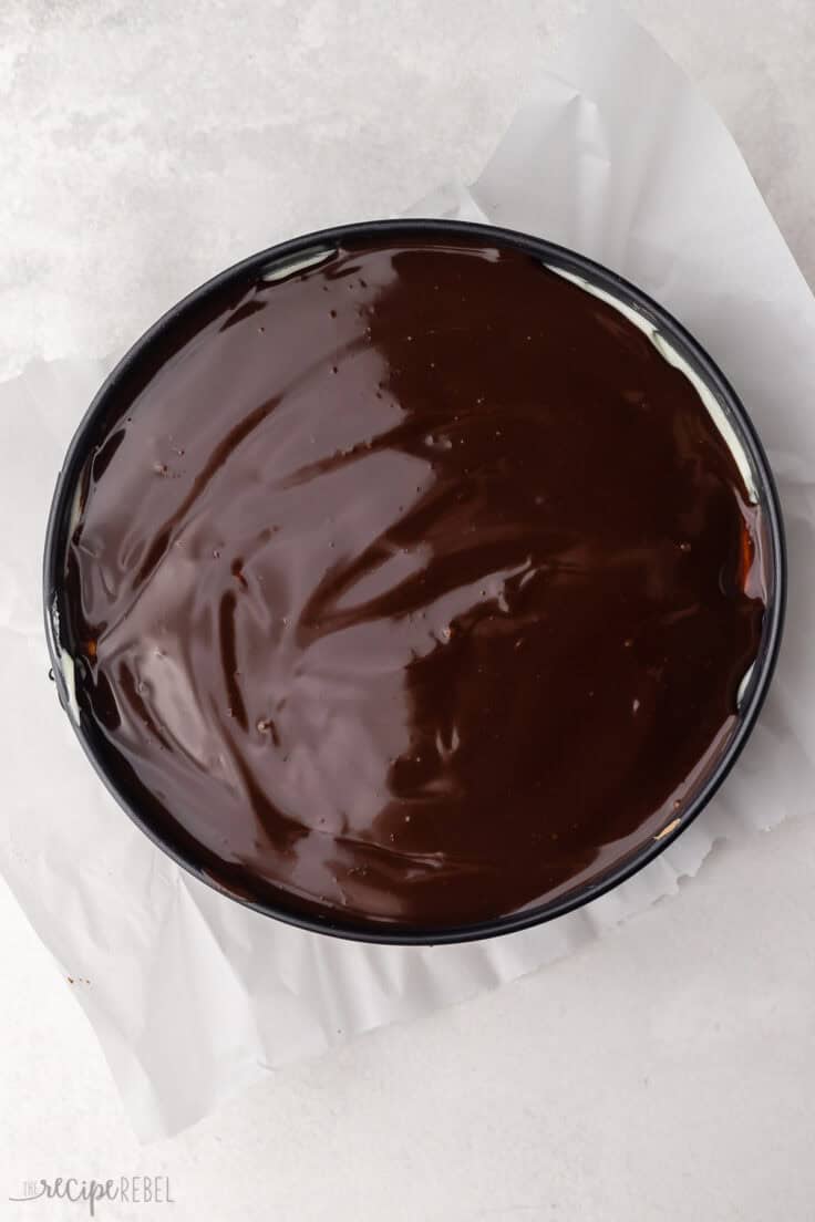 chocolate spread over top of cheesecake in pan.