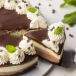 a piece of mint chocolate cheesecake coming off plate.