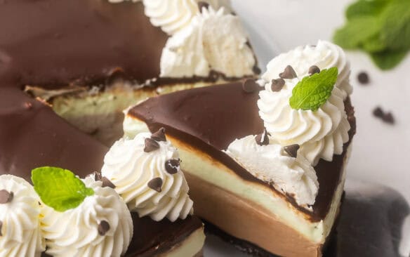 a piece of mint chocolate cheesecake coming off plate.