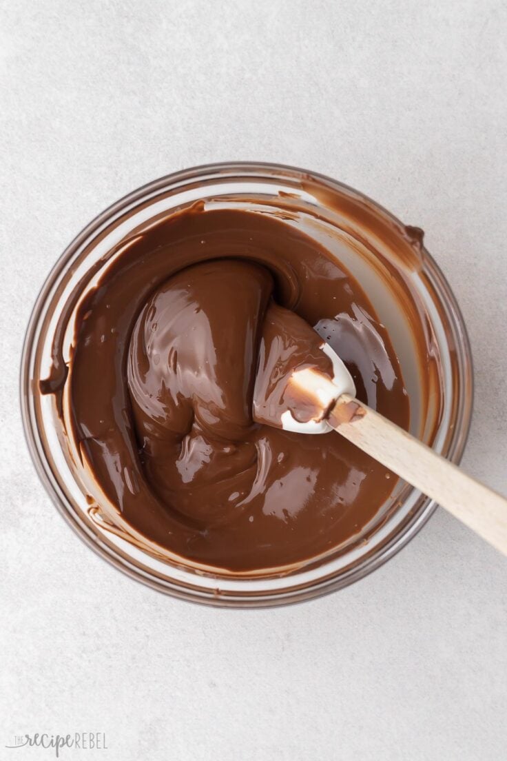 glass bowl with melted chocolate and spatula.