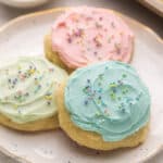 three cookies stacked on a speckled plate.