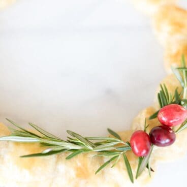 image of dough balls with brie cheese inside in the shape of a circle to resemble a wreath on a white background