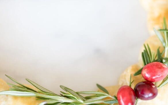 image of dough balls with brie cheese inside in the shape of a circle to resemble a wreath on a white background