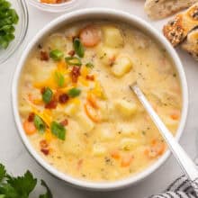 square image of a bowl of potato soup with a spoon.