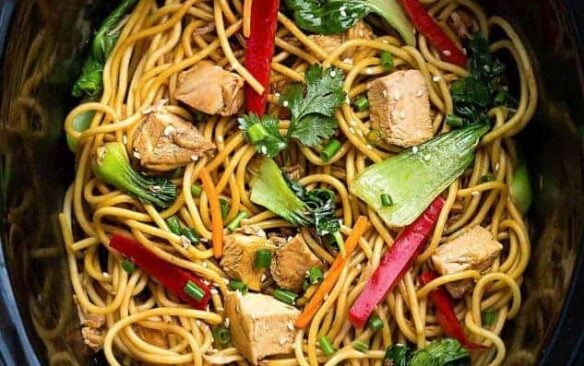slow cooker lo mein in black crockpot.
