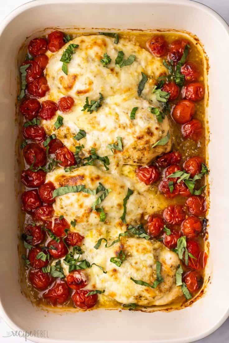 large baking dish filled with baked caprese chicken.