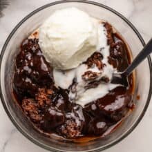 hot fudge sundae cake and vanilla ice cream in a bowl.
