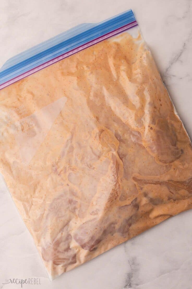 ziplock bag filled with wet ingredients and chicken.