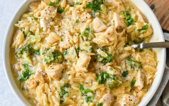 chicken broccoli orzo in white bowl.