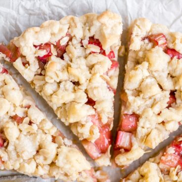 rhubarb tart with crumble topping cut into triangle slices