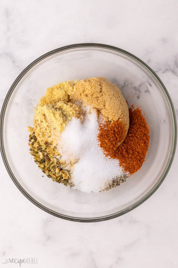 glass mixing bowl with unmixed rub ingredients.