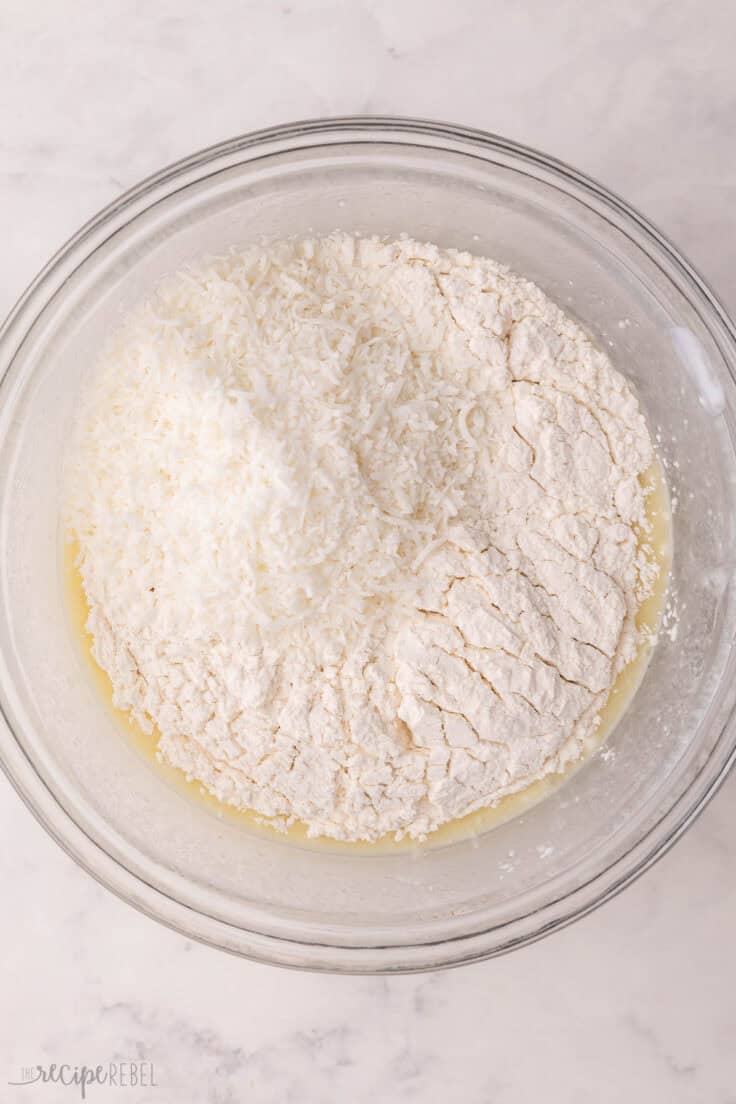 coconut and flour added to mixing bowl with other ingredients.