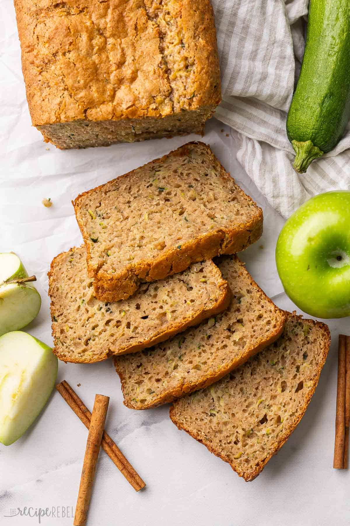 slices of zucchini apple bread with sliced apples beside.