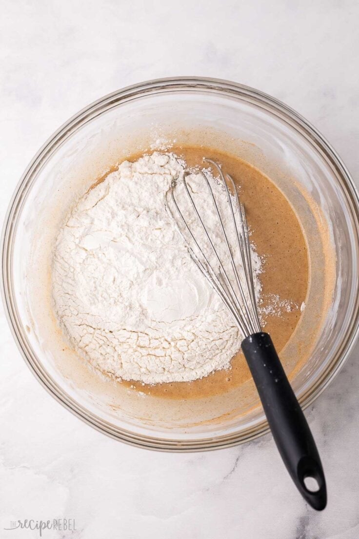 flour added to mixing bowl full of ingredients and whisk.