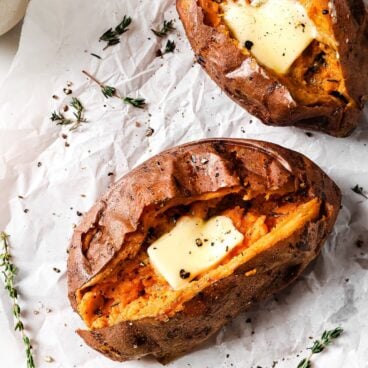 close up of an air fried sweet potato cut in half and filled with butter and herbs