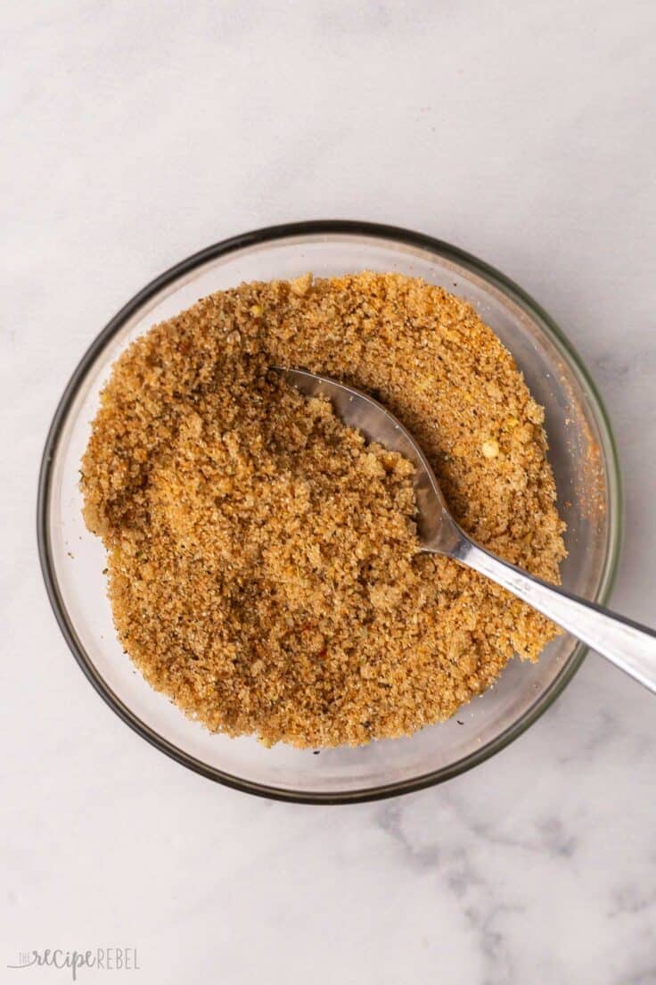 mixed rub ingredients in glass mixing bowl with spoon.